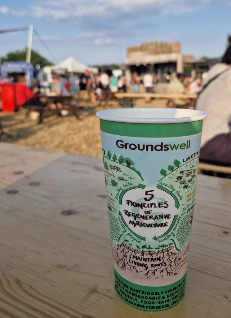 A cup featuring the 5 Principals of Regenerative Agriculture on a bench