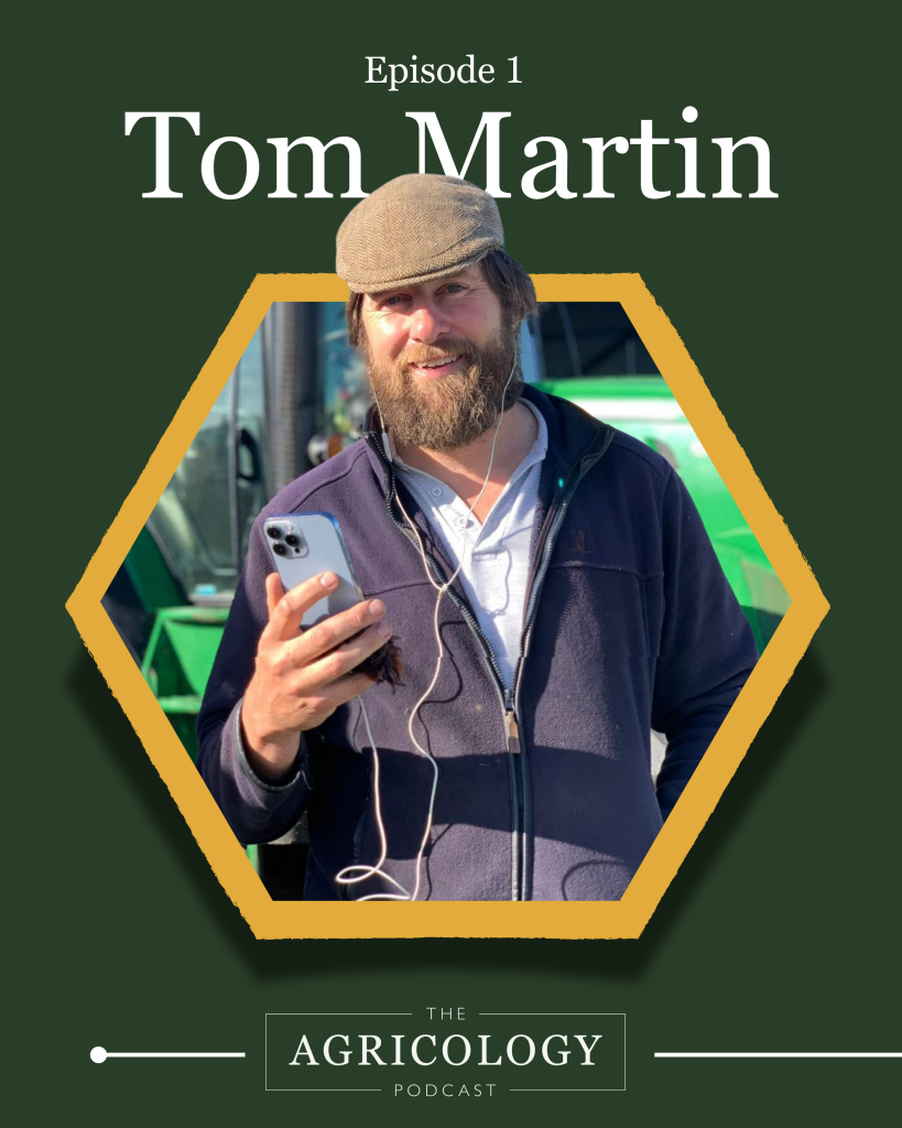 Tom Martin wearing a hat, holding a phone